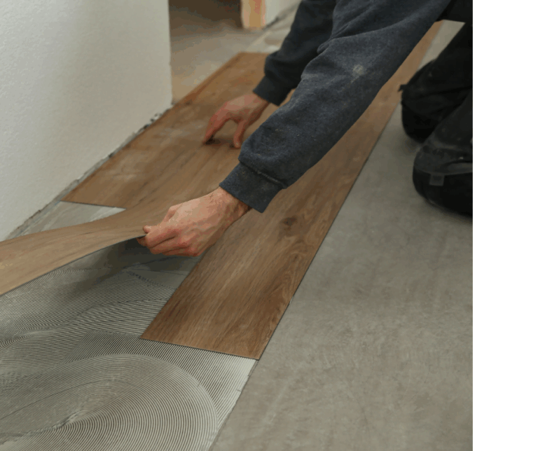 Person laying down laminate flooring planks