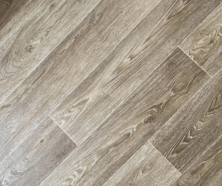 Close-up of wood grain vinyl flooring in light brown tones