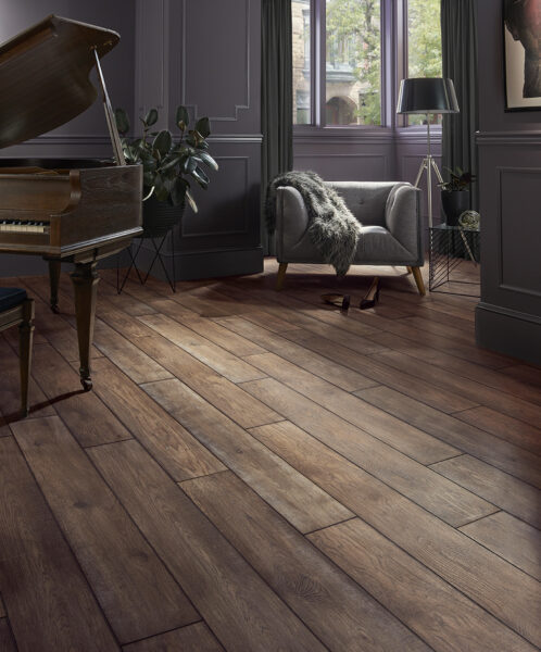 A stylish living room featuring a grand piano, cozy seating, and natural light through large windows.